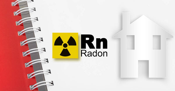 The radioactive warning symbol next to the word Radon (Rn) and a home's silhouette on a white spiral notebook.