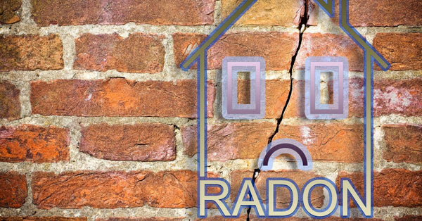 A digital outline of a house with a frowning face and the word "Radon" below it. The background is a cracked brick wall.